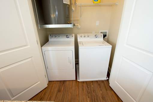 A small laundry room with a washer and dryer.