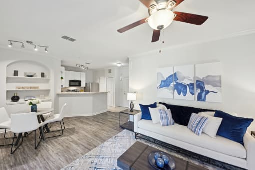 a living room with a couch and a ceiling fan