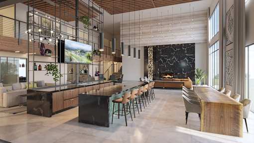 A modern kitchen with a bar area and a dining table.at Elysium, Phoenix