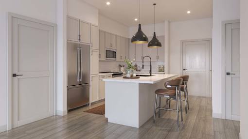 A modern kitchen with a white island and stainless steel appliances.at Elysium, Phoenix, AZ 85054
