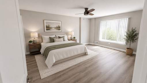 A bedroom with two beds and a ceiling fan.