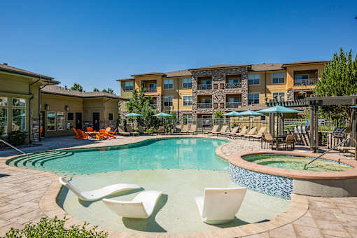 Resort-inspired swimming pool with tanning ledge - Acadia at Cornerstar Apartments