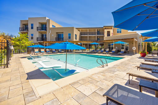 Resort-style swimming pool with tanning ledge - ABQ Uptown Apartments