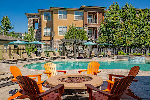 Poolside fire pit with lounge seating - Acadia at Cornerstar Apartments