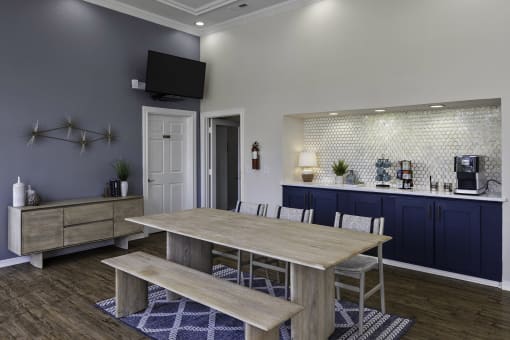 a dining room with a table and chairs and a kitchen
