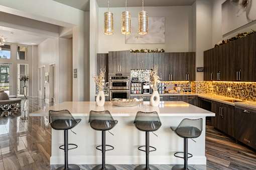 A modern kitchen with a bar area and a dining table.