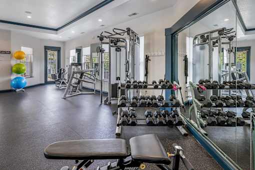 Fully-equipped fitness center with weights - Lantern Woods Apartments