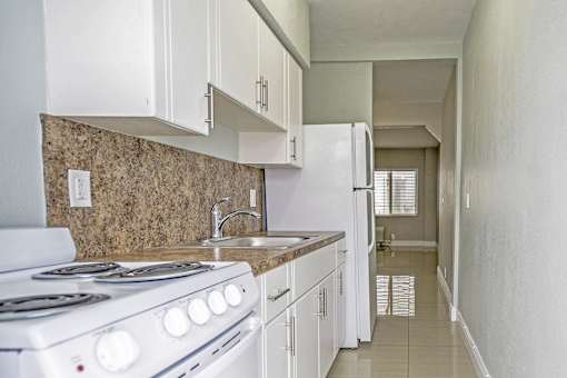 White cabinetry in select units - Helios Apartments Miami Beach