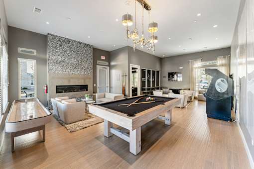 A large room with a pool table and a billiard table.