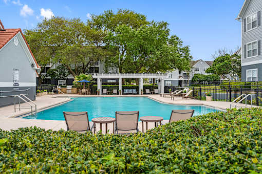 Poolside pergola and sundeck seating - The Colony at Deerwood Apartments