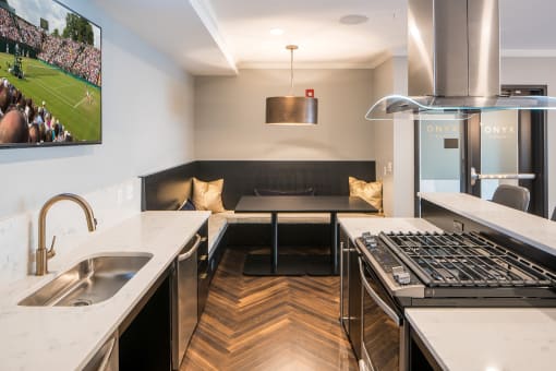 Gas stove and stainless steel sink in clubhouse kitchen - Onyx Edina