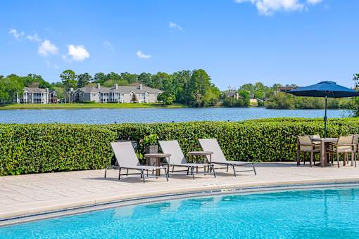 Ample seating around the pool - The Colony at Deerwood Apartments