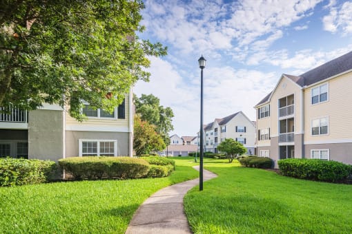 The Colony at Deerwood Apartments - Manicured landscapes with walkways