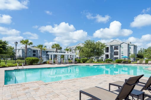 Courtney Station Apartments - Resort-style pool with pergola and seating area