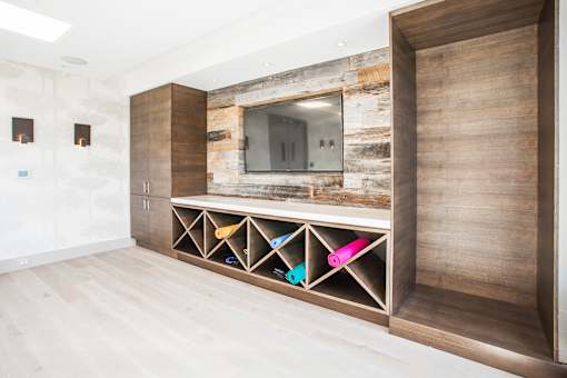 A modern room with a wooden wall and a TV.