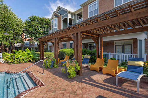 Pool-side lounge area with pergola coverage - Belle Harbour Apartments