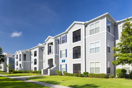 Courtney Station Apartments - Building exterior with manicured lawn