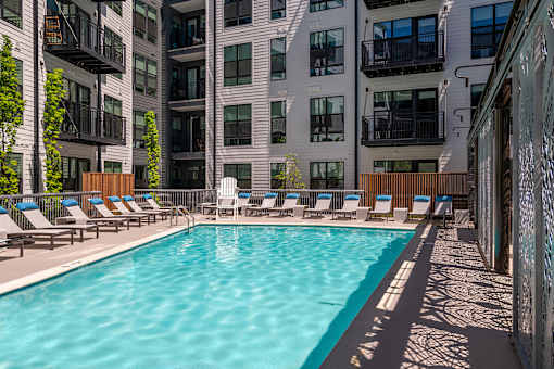 Swimming pool with lounge chairs - Rockwell at Crown