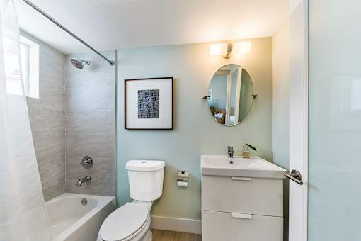 A bathroom with a toilet, sink, and bathtub.