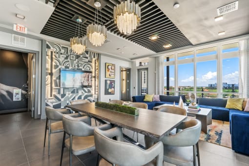 Axio at Carillon lounge with conference table, couches and a TV