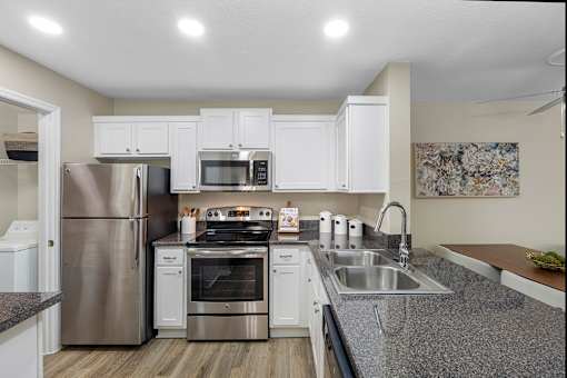 Stainless steel appliances available - The Colony at Deerwood Apartments