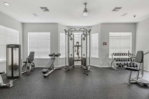 Fitness center with strength training equipment - Egret's Landing Apartments
