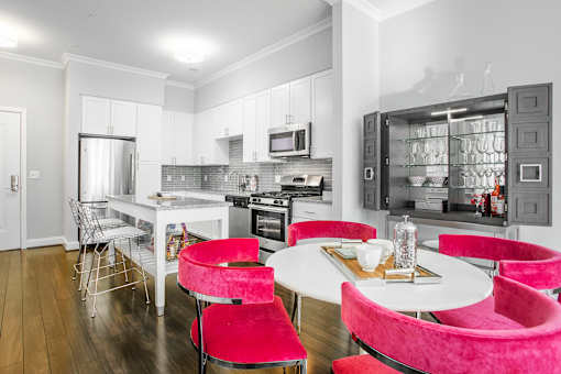 A modern kitchen with a dining table and chairs.