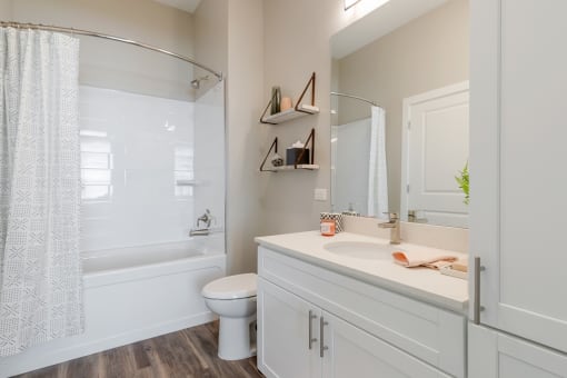 The Airdrie at Paoli Station bathroom with soaking tub and curved shower rod