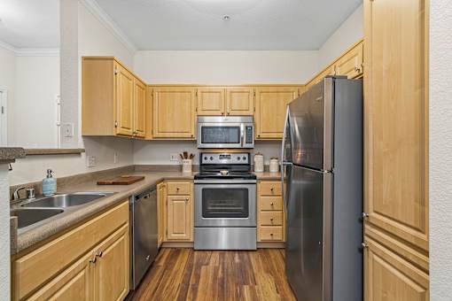 A kitchen with wooden cabinets and stainless steel appliances.