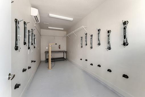 A white room with black handles on the wall.