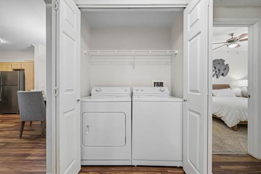 A white washer and dryer in a small room.