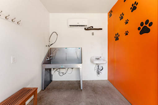 A room with a sink and a table with a grill on it.