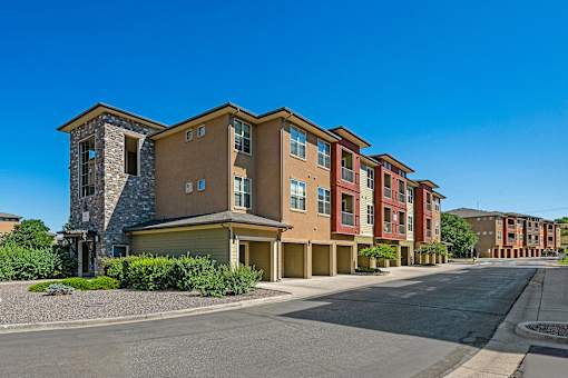 A row of modern apartment buildings with a clear blue sky above.