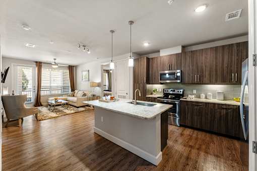A modern kitchen with wooden cabinets and a white island.
