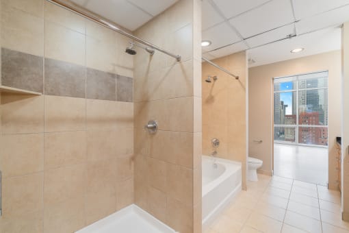 a large bathroom with a shower and a tub in it