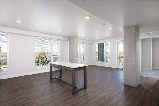 A large, empty room with a long table in the middle.