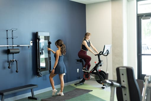 A woman is working out on an exercise bike in a gym.