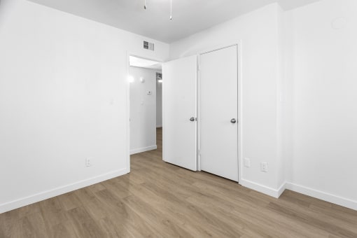 an empty room with white walls and white doors