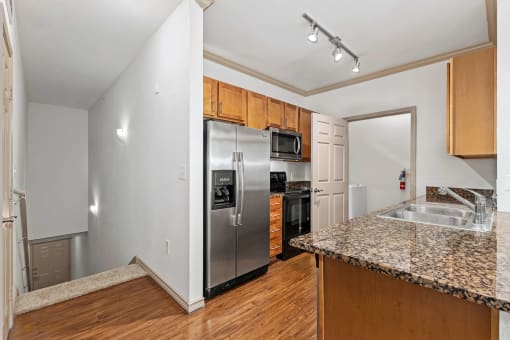 kitchen with access to stairs leading to the garage