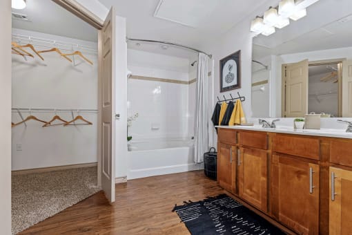 a bathroom with a shower and a sink and a mirror