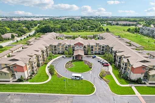 A large apartment complex with a circular driveway in the middle.