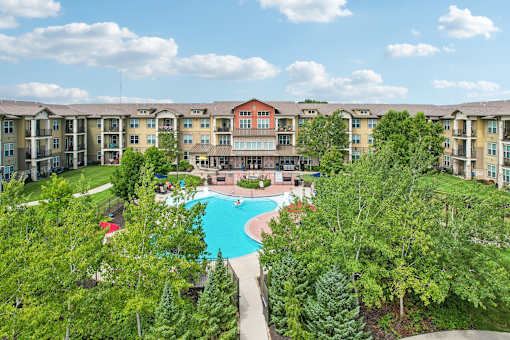 A large apartment complex with a pool in the middle.