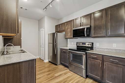 A kitchen with wooden cabinets and stainless steel appliances.