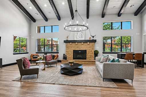 A living room with a fireplace and a chandelier.