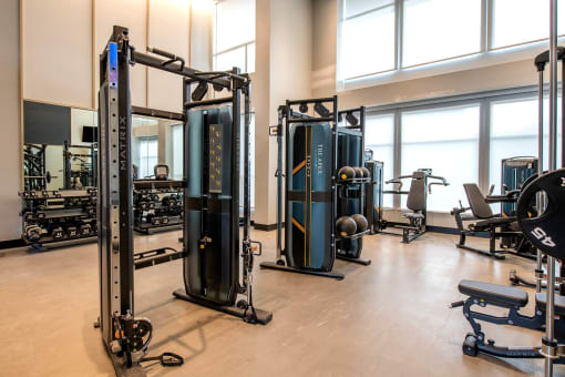 apartment gym with large windows and workout machine equipment at The Apex at CityPlace, Overland Park, KS, 66210