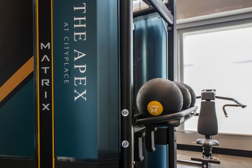two weighted balls in an indoor gym with a bench in the background at The Apex at CityPlace, Kansas, 66210