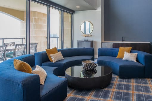 semi-circular couches around a circular coffee table indoors at The Apex at CityPlace, Overland Park, KS