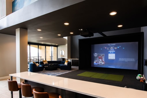 indoor movie theater screen with couches and barstools around a counter at The Apex at CityPlace, Overland Park, KS, 66210