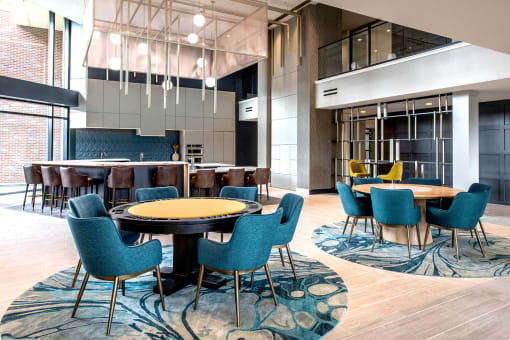 two circular tables with 6 chairs around each in an indoor kitchen at The Apex at CityPlace, Overland Park, 66210
