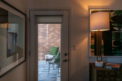 a glass door looking out onto a patio from indoors at The Apex at CityPlace, Overland Park, 66210